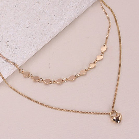 Thin gold necklace with small pendants